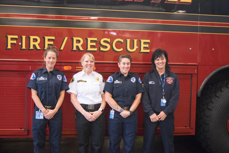Female Port of Seattle firefighters standing in front of fire truck.