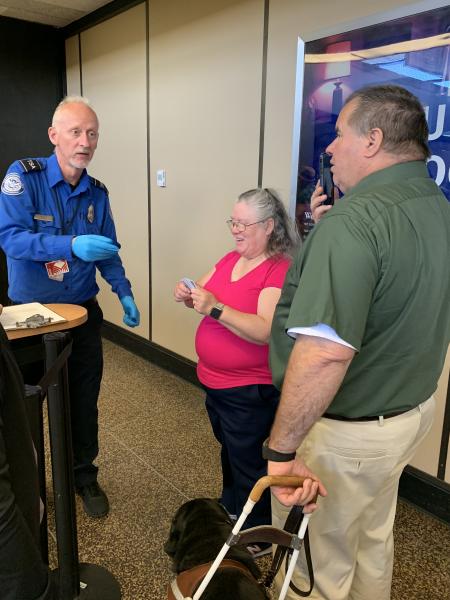 Larry Watkinson travels through security with his wife, Kathy, and service dog, Huey.