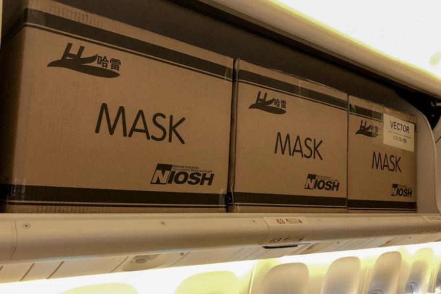 Boxes of masks in the overhead bins