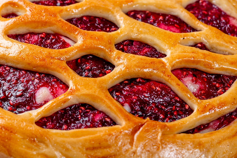 close up of raspberry pie with a lattice crust