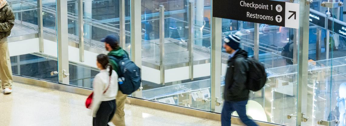 Travelers walking through the light filled terminal