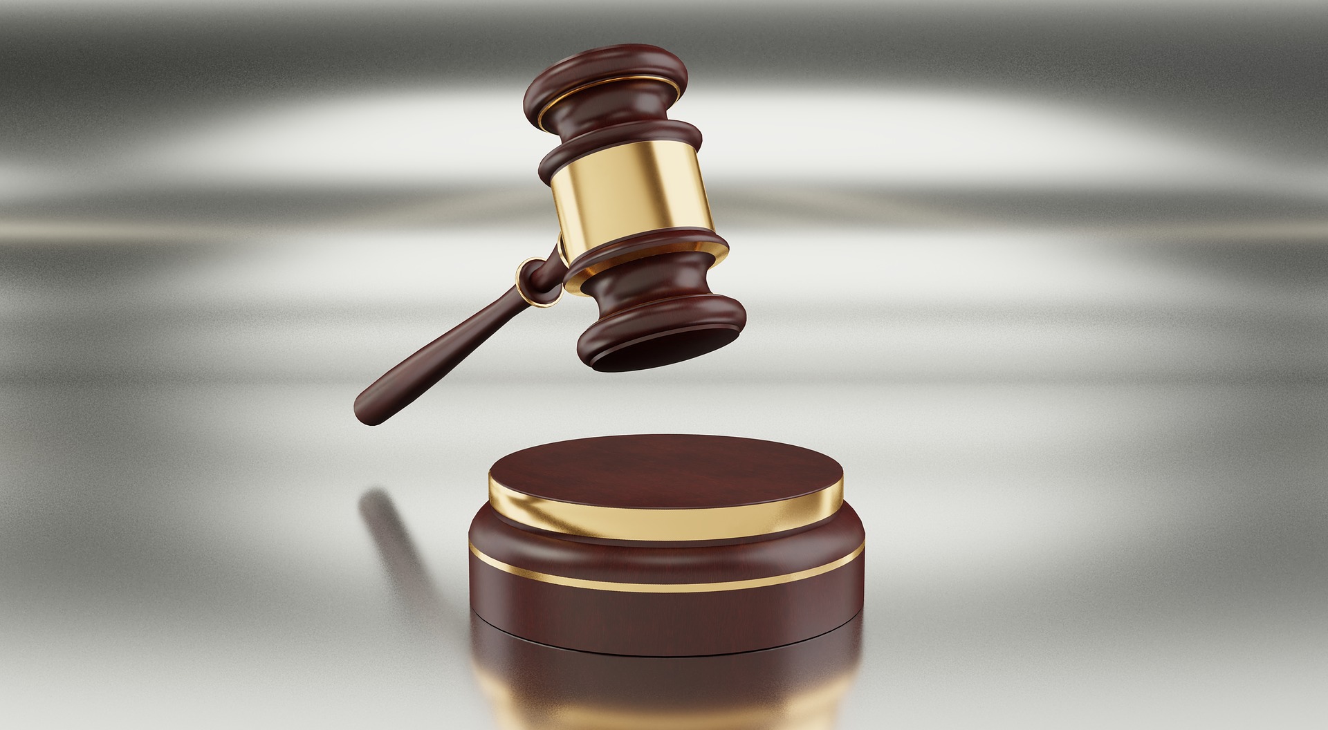 Gavel in front of a grey background