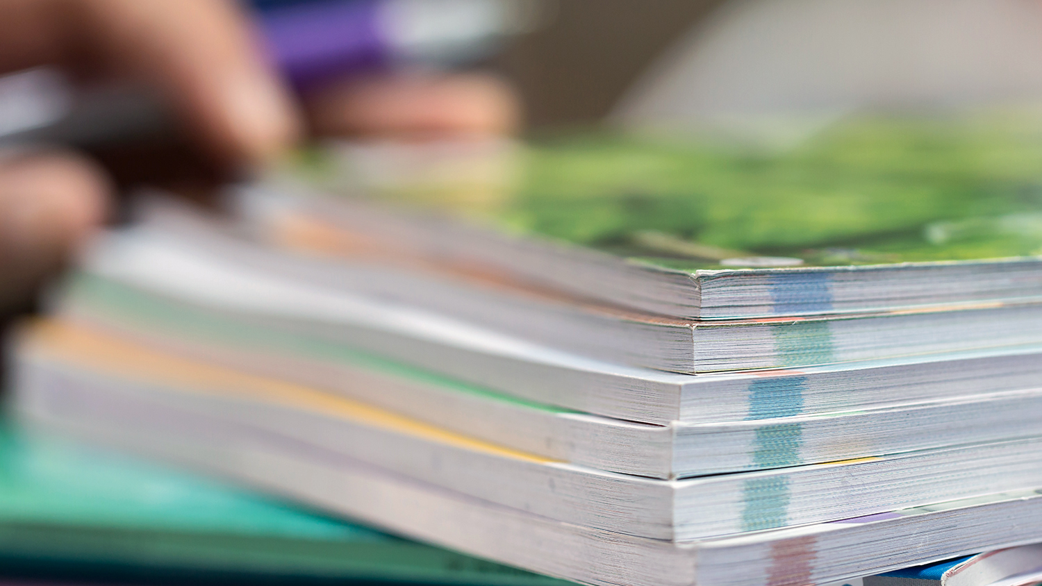 Stack of documents with green sticky notes stuck on top