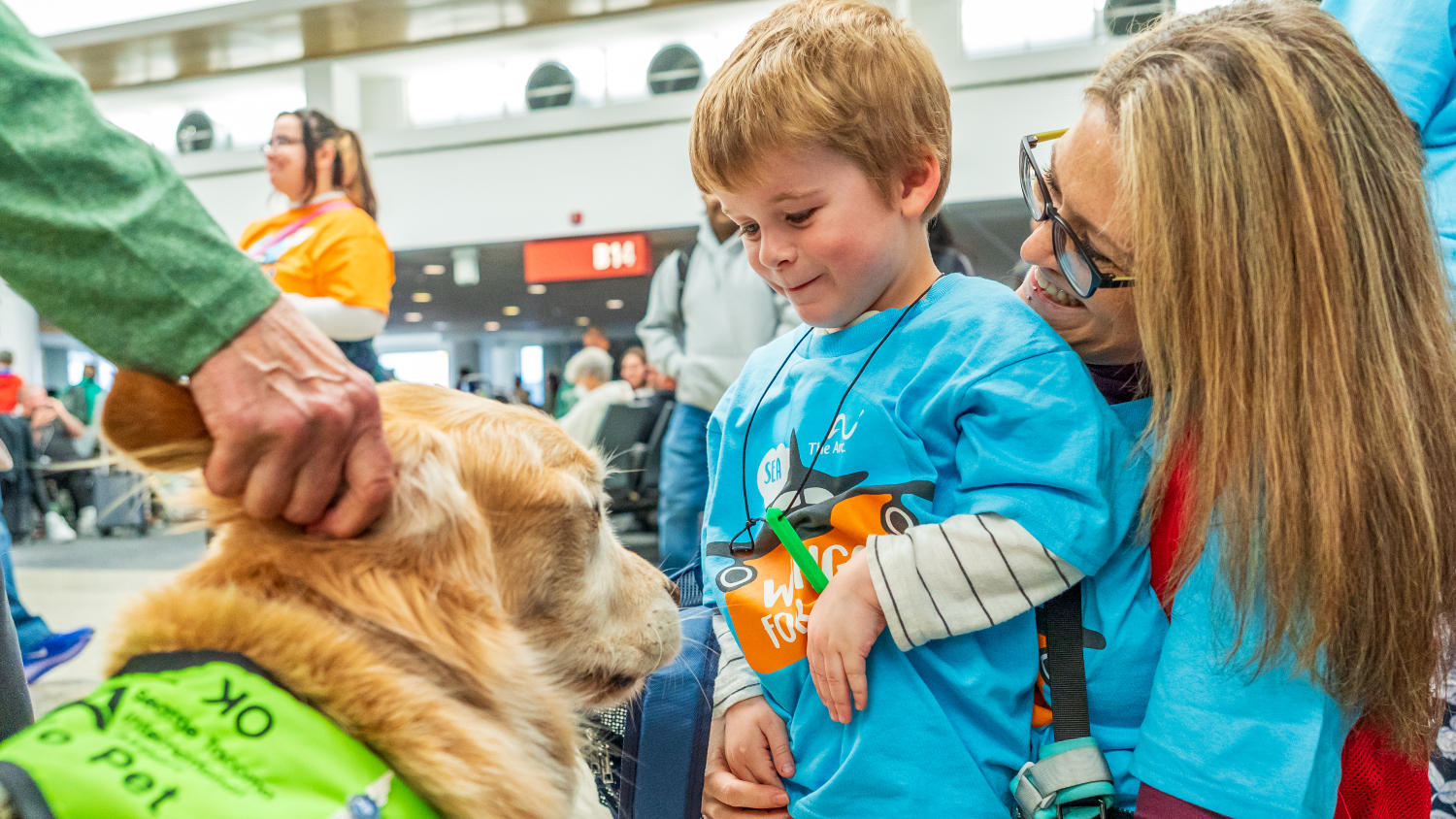 A boy and his mother meet one of the SEA Pups at the Wings for All event on Saturday, October 17