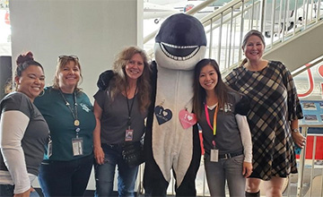 Olive the Orca greets committee members