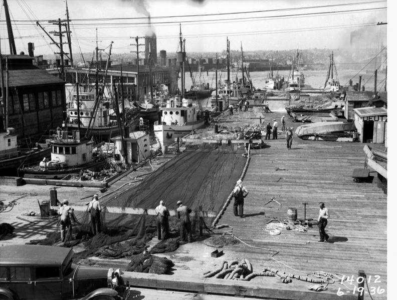 Fishermen repair nets spread out on the docks , Seattle, ca. June 19, 1936