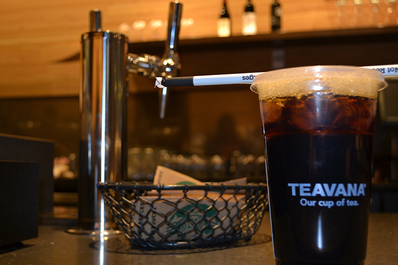 A close up of a cup of Starbucks iced tea on the counter.