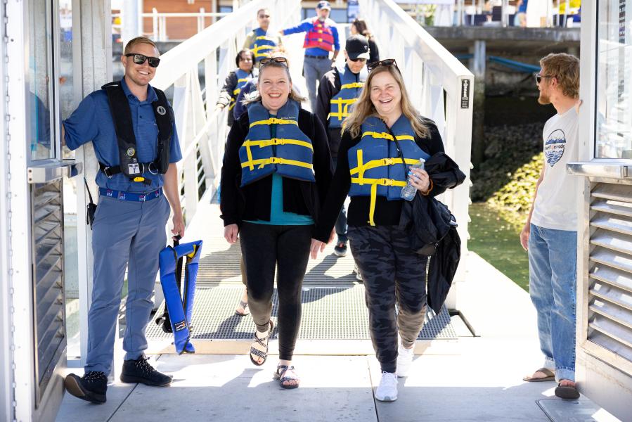 Sailors walking down I dock at Shilshole Bay Marina