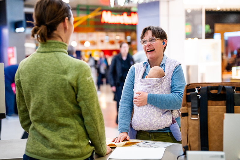 SEA staff member helps traveler at information desk.