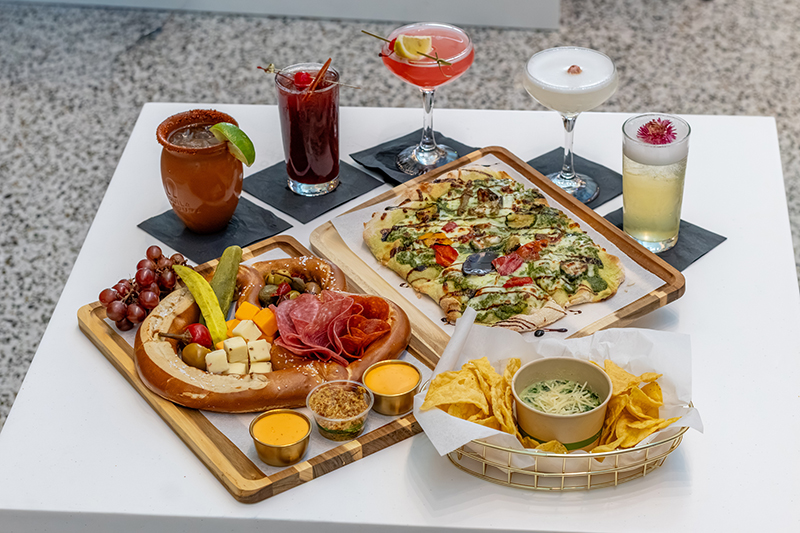 Fruity summer cocktails, along with the Bavarian pretzel charcuterie board, spinach artichoke parmesan dip, and vegetarian flatbread.