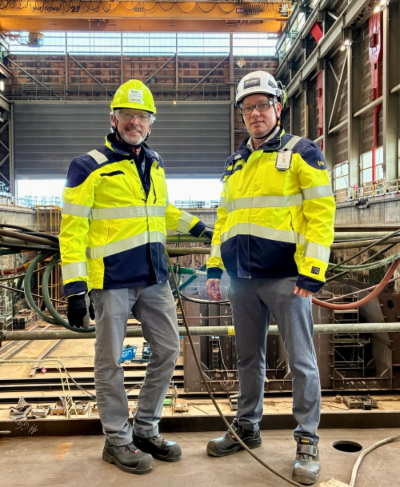 Commissioner Felleman with Helsinki Shipyard managing director Kim Salmi, in a bay where an icebreaker is currently under construction