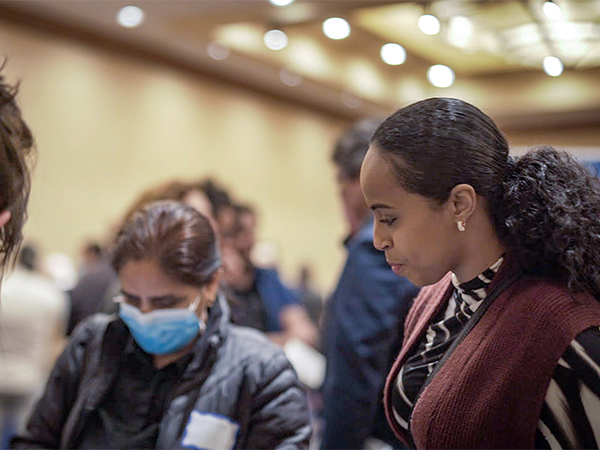 Commissioner Mohamed talks and listens to participants at the Job Fair designed to help our neighbors find family wage jobs