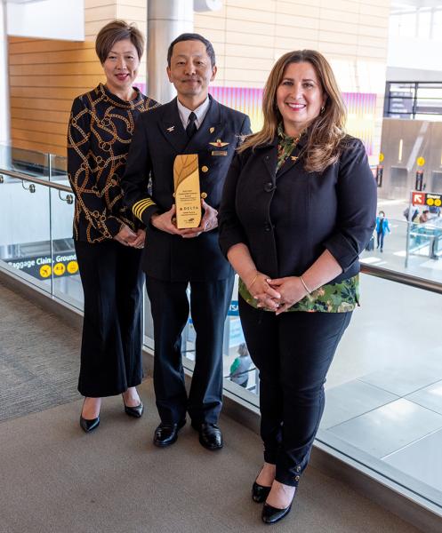 Delta staff poses with award