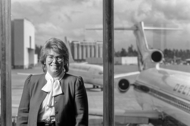 black and white photo of Andrea Riniker next to a Delta jet 