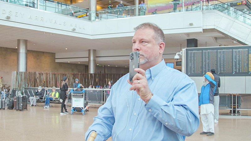Traveler who is blind, uses Aira technology.