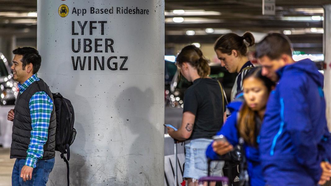 Passengers at Sea-Tac Airport await pick up by a ride-share, June 2018