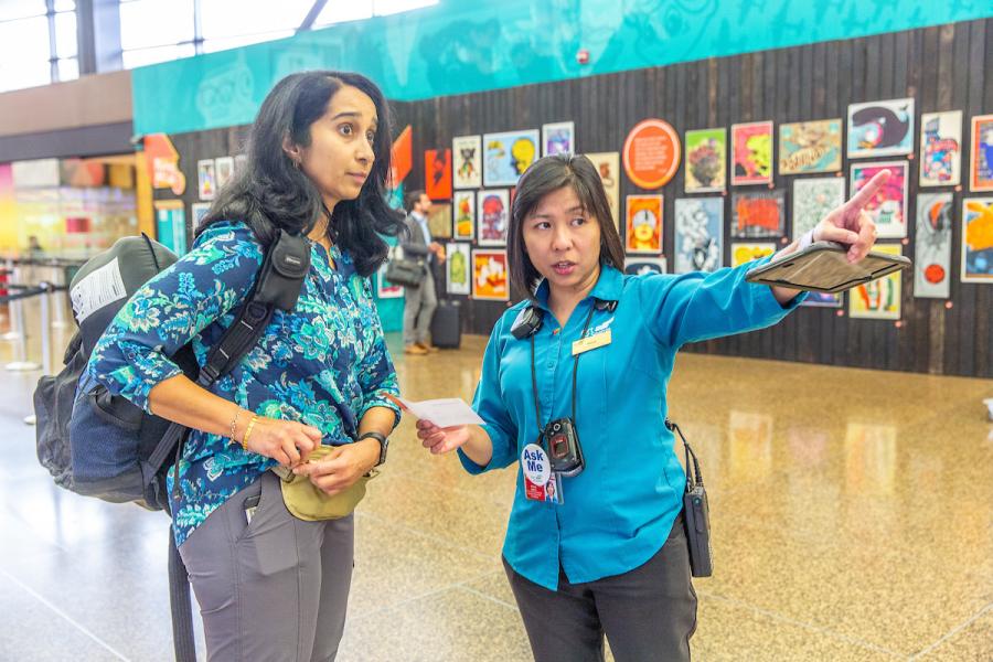 Airport Pathfinder, Sheryl Molina, helping a traveler at Sea-Tac, 20 September 2018