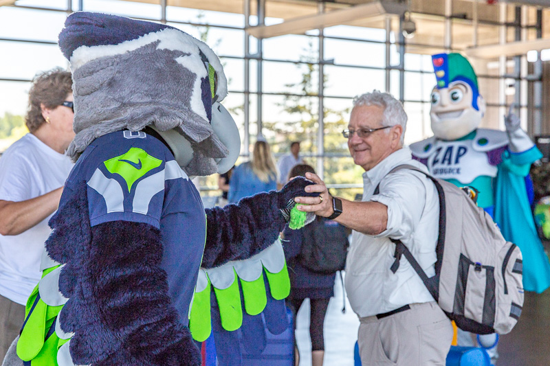 Link LIght Rail passenger with mascots