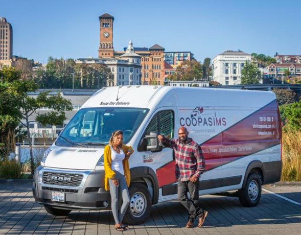 Markiss (right) and Ashley (left) in front of their company van