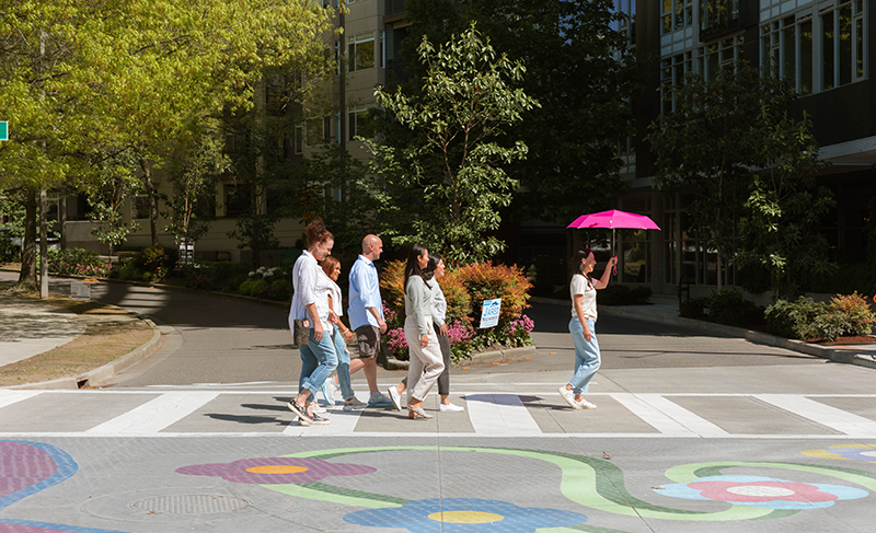 People walk across the street on a Bellevue Bites Tour