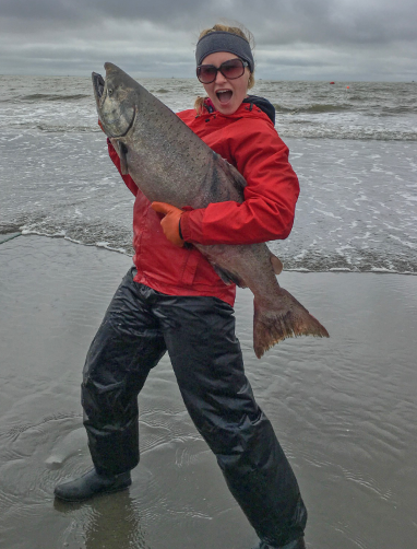 Evelyn Clark on the beach holding a salomon