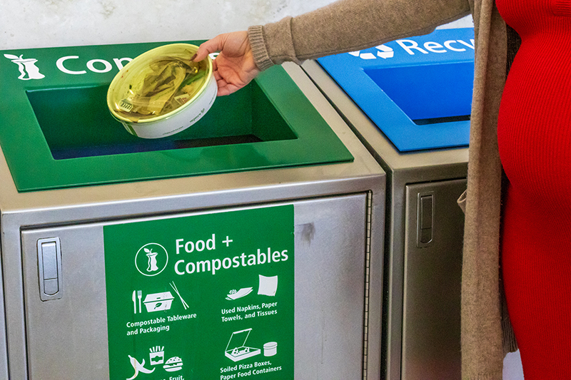 Passenger using the compost bin at SEA