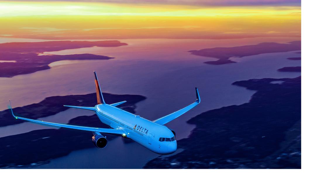 Delta aircraft in flight with beautiful sunset