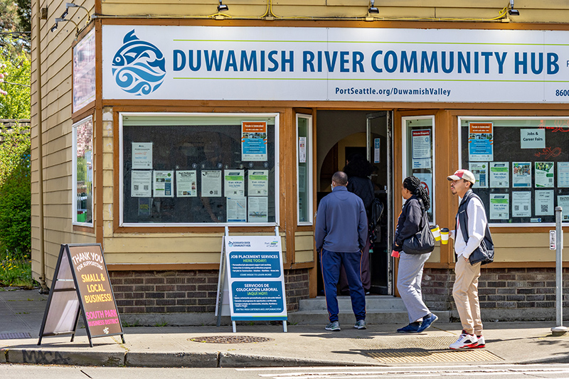 Community members walk into the Duwamish River Community Hub during a job fair.