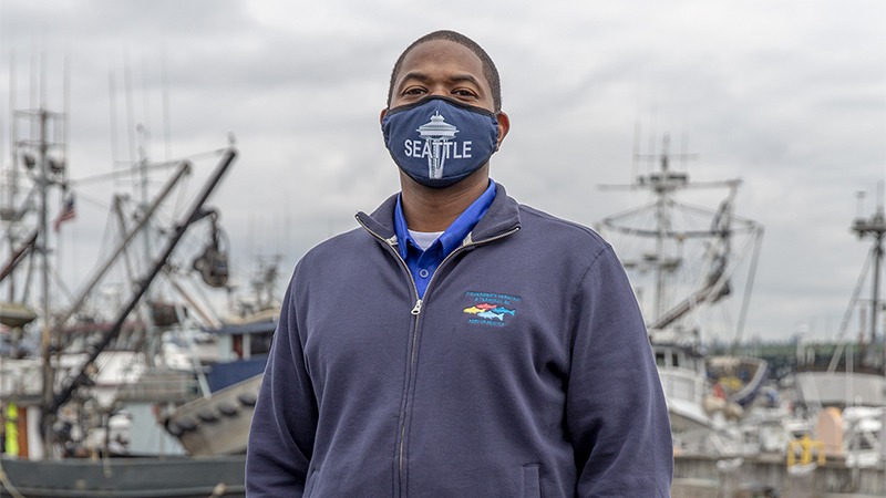 Port of Seattle Fishermen's Terminal employee with fishing fleet visible in the background, Nov. 2020
