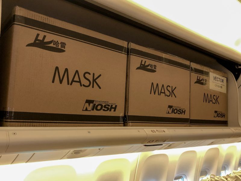 EVA Air carrying boxes of masks in passenger overheads and seats