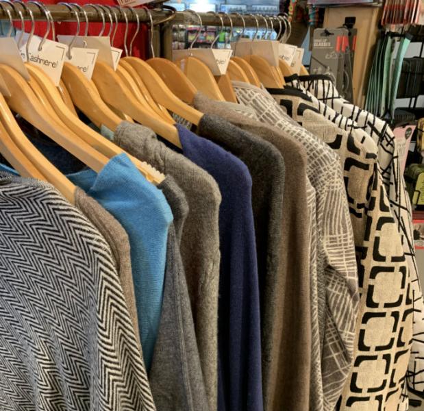 warm and cozy sweaters on a rack