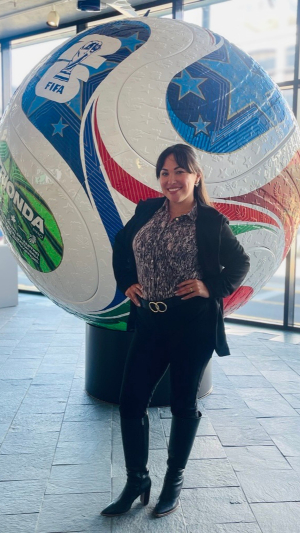 Commissioner Hasegawa in front of the region’s largest official match ball, in the Pier 69 lobby
