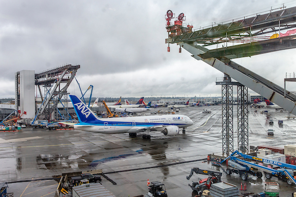 ANA passenger jet passes beneath what will soon be the new International Arrivals Facility Pedestrian Walkway