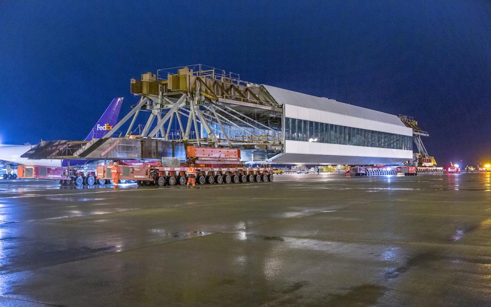 Center span of IAF pedestrian walkway begin moving