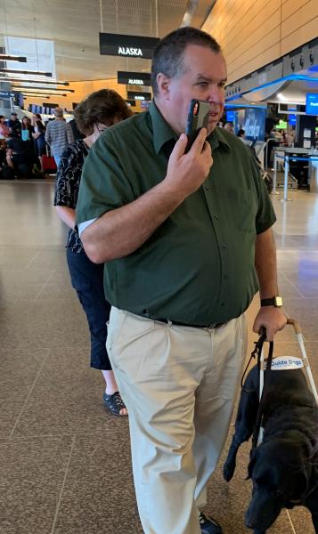 Larry and his service dog Huey navigate the airport using Aira technology 