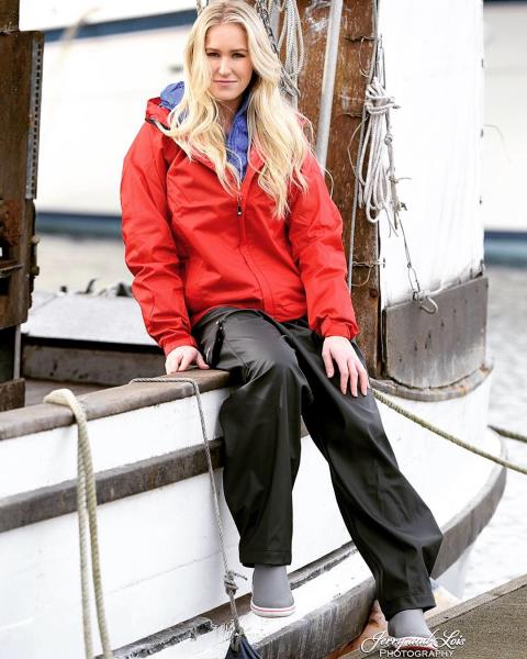 Evelyn Clark in fishing gear sitting on the side of a boat