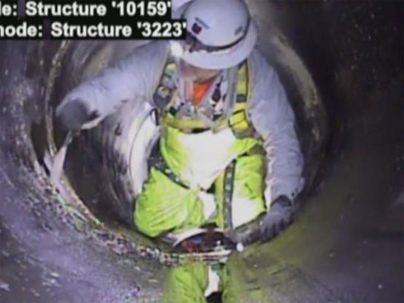worker installing repair band inside pipe