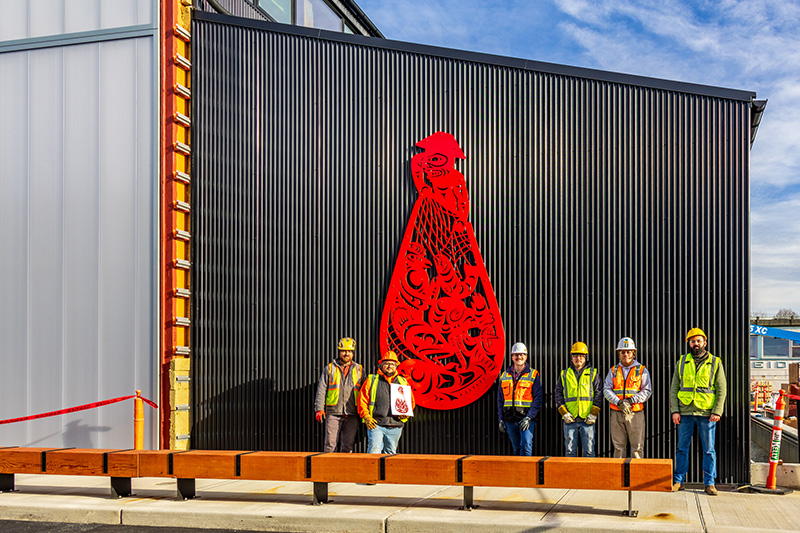 Ty Juvinel and crew pose by installed "Beach Seining" piece