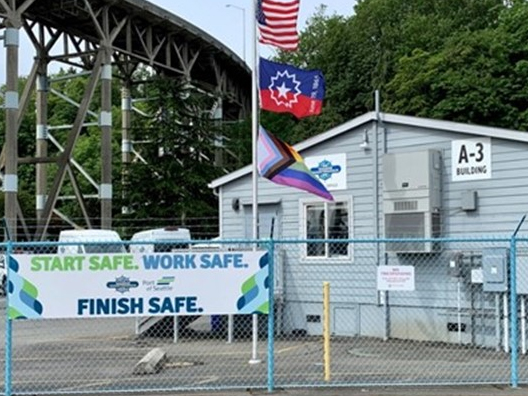 Junteenth and Pride flags fly over the Maritime Maintenance facility at Pier 91