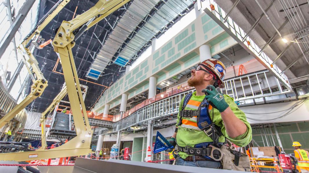 Craft worker at the North Satellite looking up