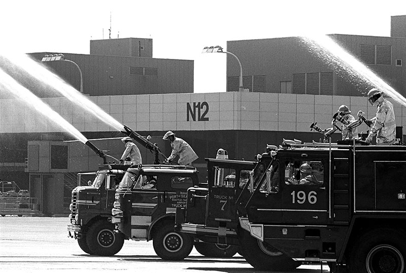 Black and white photo of fire trucks in front of North Satellite at the fire station dedication in 1979.
