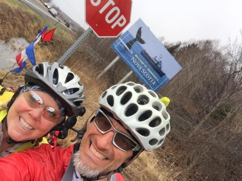 Stephanie and Merrick reach their destination and pose by the Nova Scotia sign