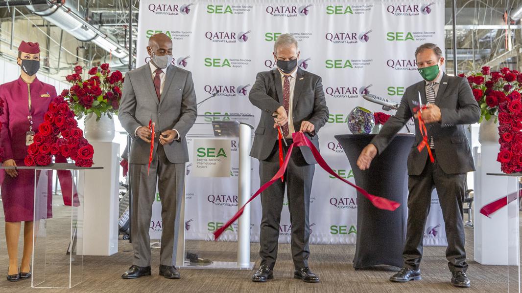 SEA Airport Managing Director Lance Lyttle and Commissioner Peter Steinbrueck cut the ribbon with a Qatar executive for inaugural flight from Doha to SEA, Jan. 29, 2021