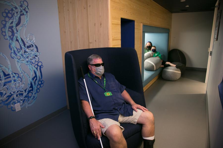 A family of travelers using the sensory room to take a break from the hustle and bustle of the terminal.
