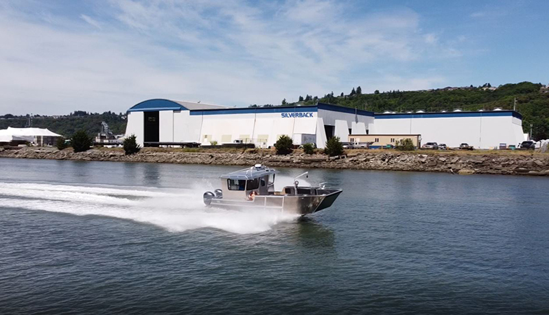 Silverback Marine boat with Silverback Marine headquarters in the background.