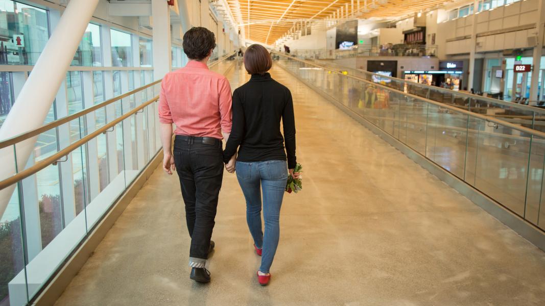 Zac Cohn and Lauryl Zenobi stroll through the airport.