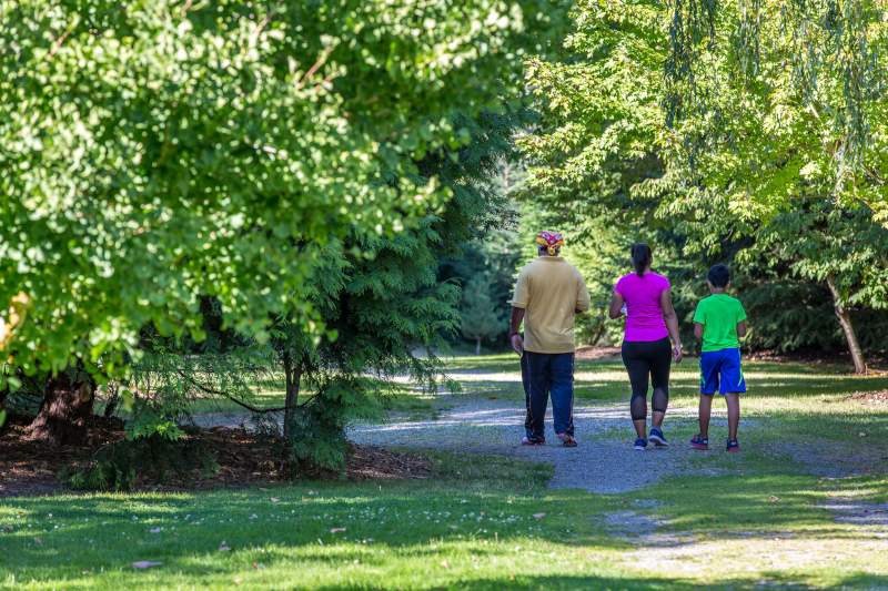 People walking in the trees at Terminal 107 Park