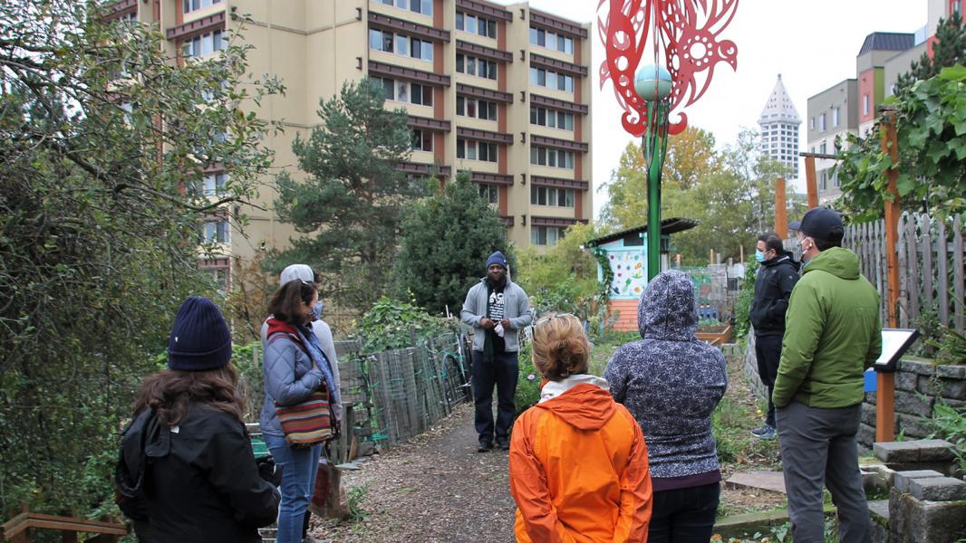 Participants listen to the tour guide on a Seattle Community Tour.