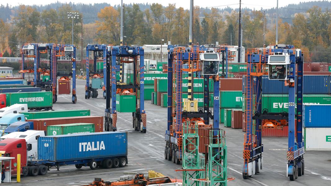 Trucks loading with containers.