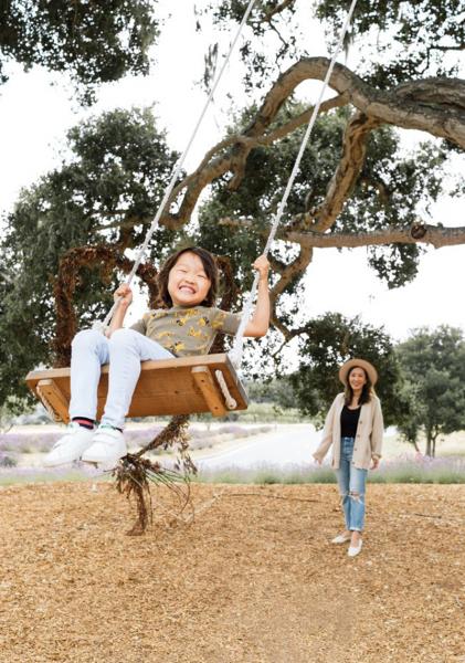 Angela and family on a swing set.